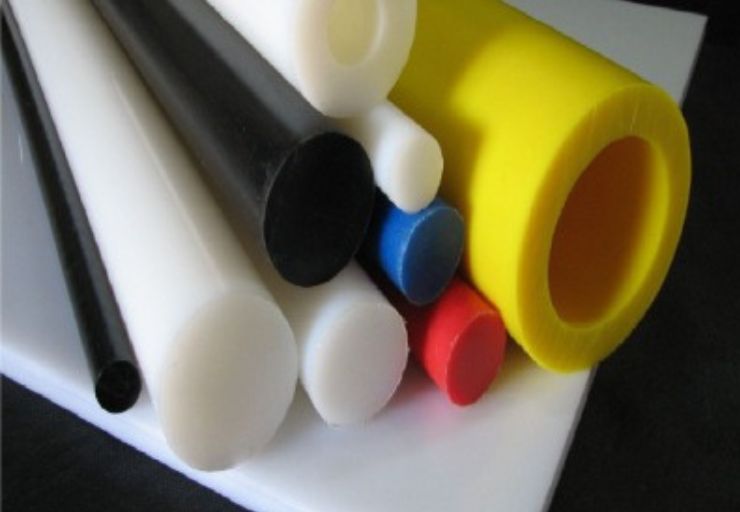 Barras redondas de UHMW em branco leitoso empilhadas horizontalmente, textura antiaderente lisa, fundo industrial neutro, iluminação frontal suave, fotografia de produto realista